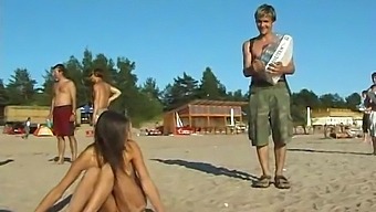 A Young And Stunning Girl Enjoys Beach Play In The Nude